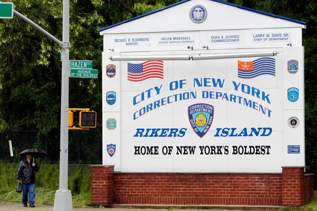 A Correction Department sign outside the entrance to Rikers Island.